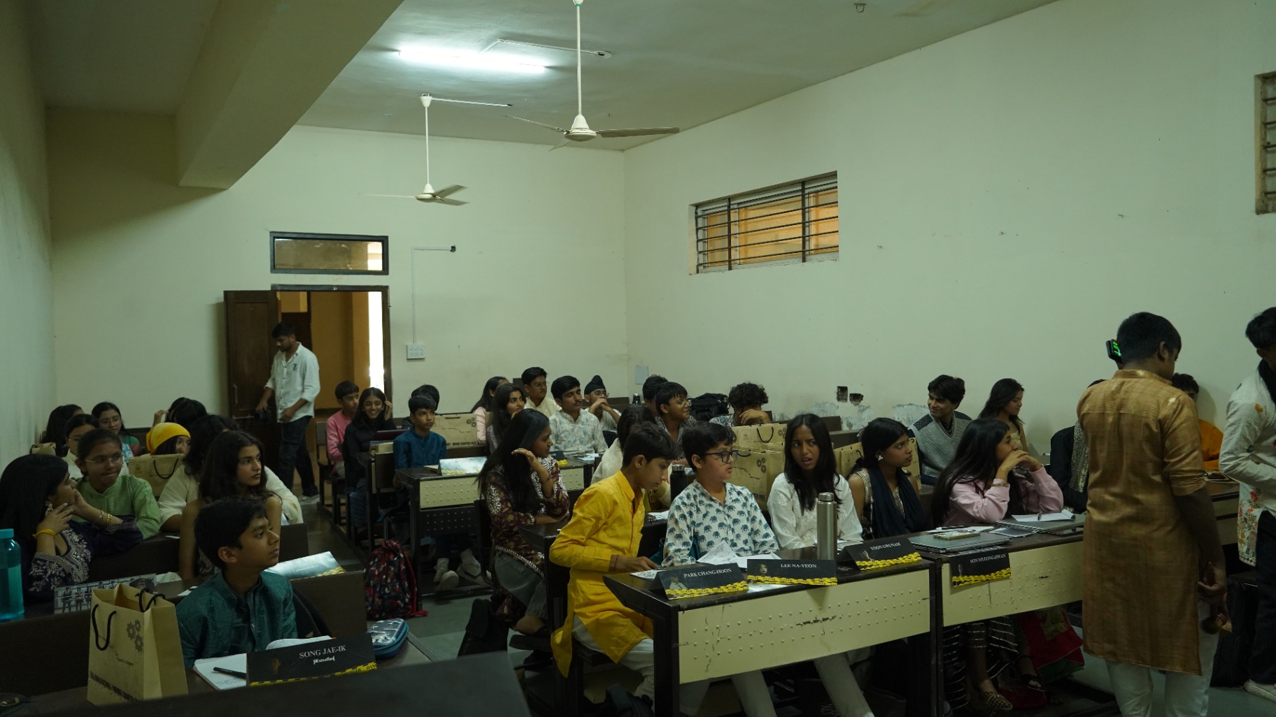 A full TMF committee room with delegates and country placards on the desks.