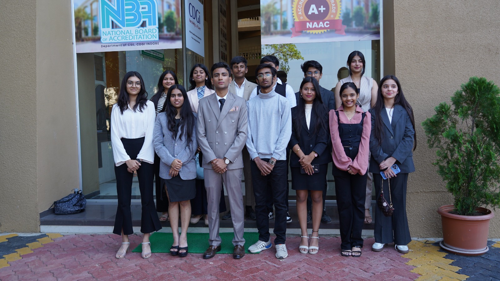A formal TMF group portrait of students outside the venue.