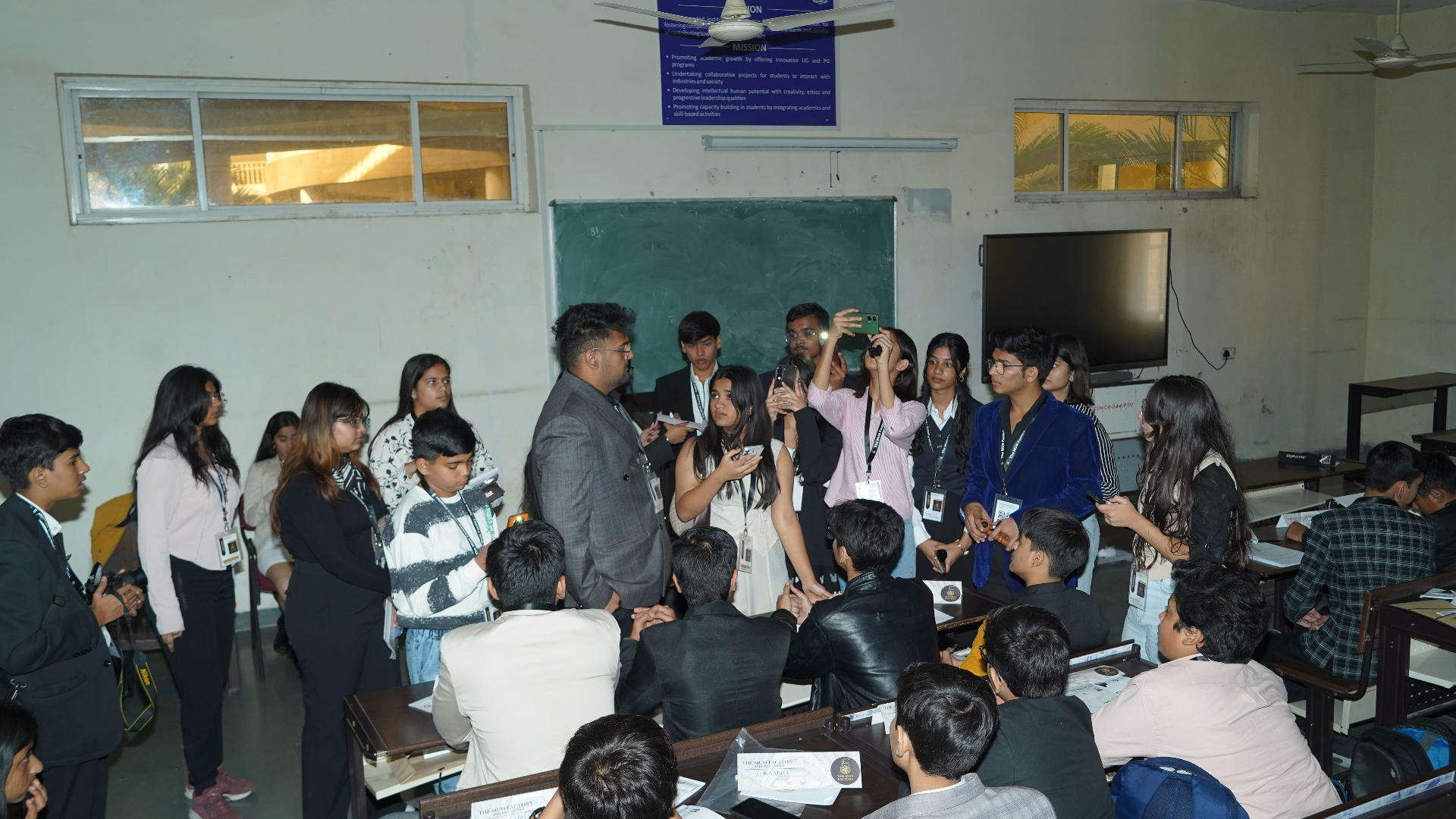 Students gathered around a speaker in a TMF classroom discussion circle.