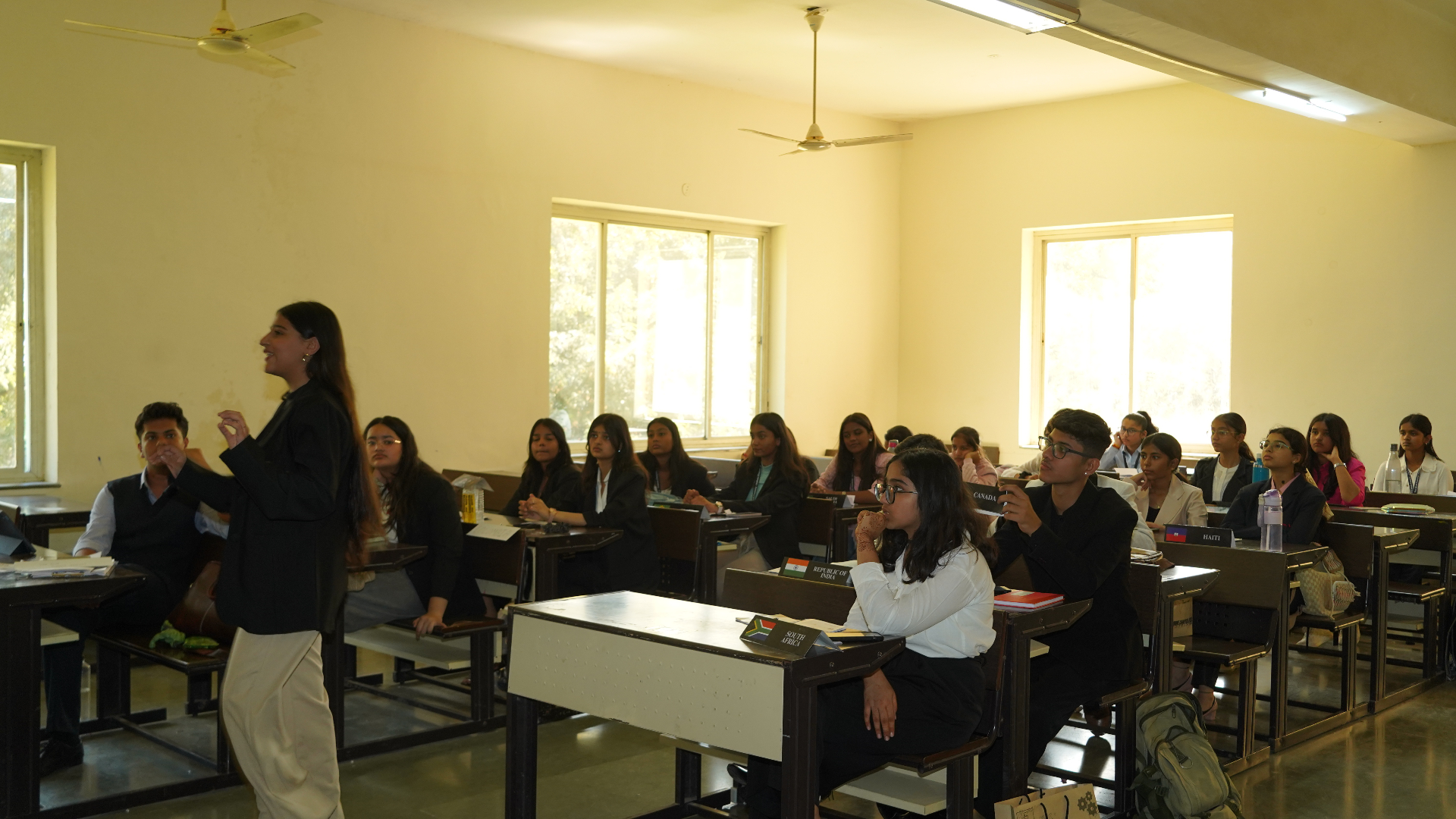 Delegates engaged in a TMF committee session during daytime debate.
