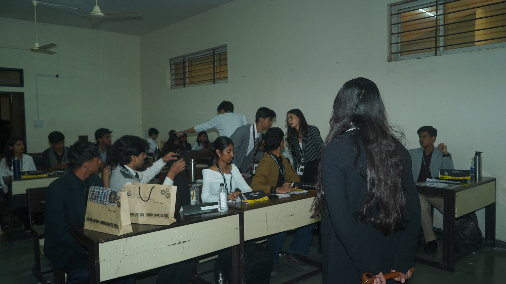 Students gathered in a TMF committee room during an active session briefing.